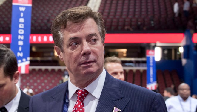 In this July 18, 2016 file photo, then-Trump campaign chairman Paul Manafort walks around the convention floor before the opening session of the Republican National Convention in Cleveland. A spokesman for President Donald Trump’s former campaign chairman, Paul Manafort, says that FBI agents served a search warrant at one of his homes.