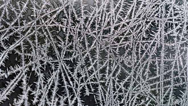 Frost patterns form on the window of a St. Joseph, Mich., home Tuesday, Jan. 2, 2018, after a night of sub-zero temperatures.