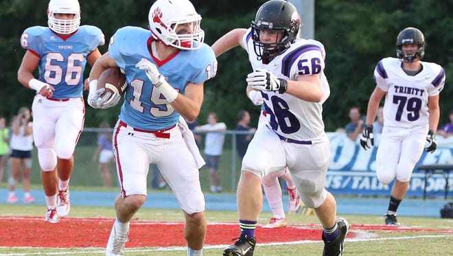 USJ's Holland Hawks carries the ball, pursued by TCA's Zachary Yarbrough.