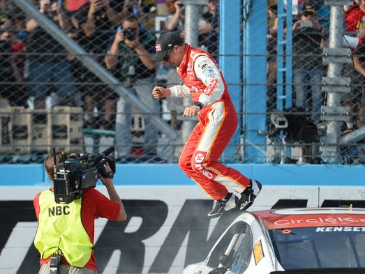 Matt Kenseth jumps off his car at Phoenix Raceway after