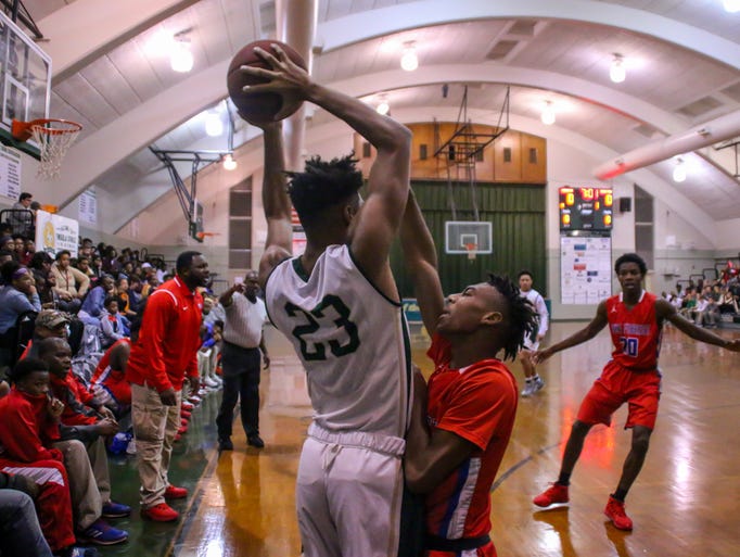 Catholic's Nitrell Bledsoe (23) looks to pass the ball