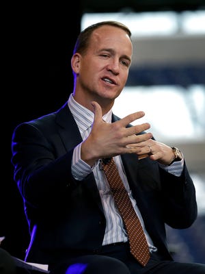Former Indianapolis Colts quarterback Peyton Manning answers questions from Marian University's Will Hampton after he was honored with the Marian University Clayton Circle of Honor Tuesday evening at Lucas Oil Stadium. 