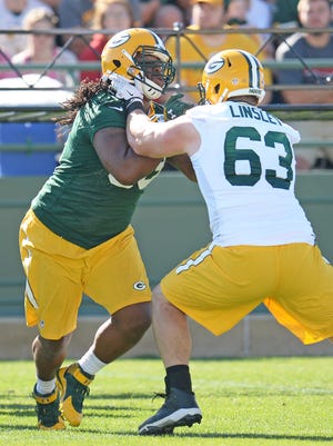 Center Corey Linsley (63) battles Josh Boyd (93) during one on one battles at Green Bay Packers Training Camp at Ray Nitschke Field July 31, 2015.