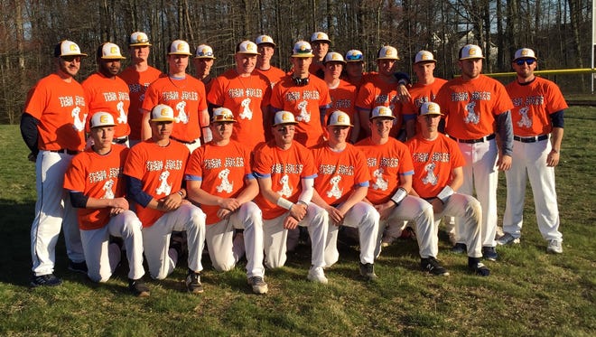 The Colonia baseball team poses for a photo before Sunday night's Autism Awareness Game against Bishop Ahr