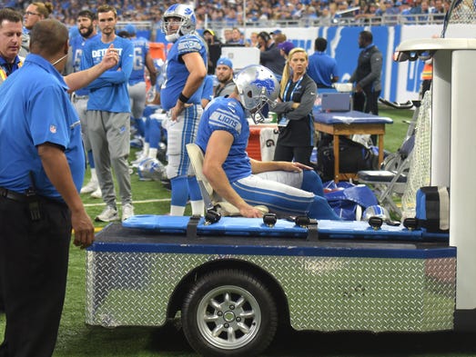 Lions punter Kasey Redfern is taken off the field in