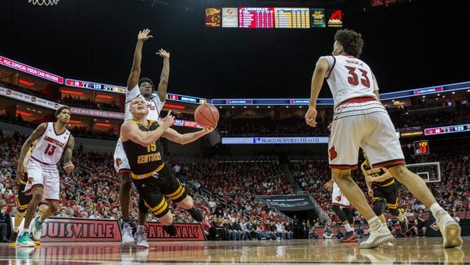 Northern Kentucky's Tyler Sharpe is fouled by Louisville Darius Perry during NIT action at the YUM Center. March 13, 2018.