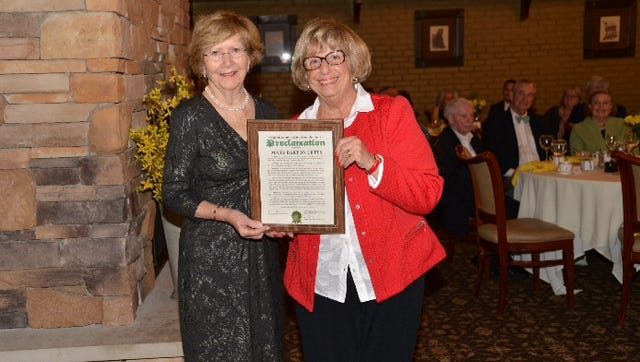 Mary Barton Letts (left)  receives a proclamation from Oakland County Commissioner Shelley Goodman Taub honoring Letts for her efforts to preserve the Barton farmhouse.