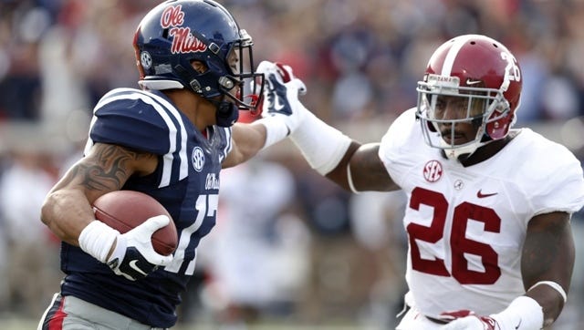 Ole Miss tight end Evan Engram, right, fights off Alabama safety Landon Collins in a game earlier this season.