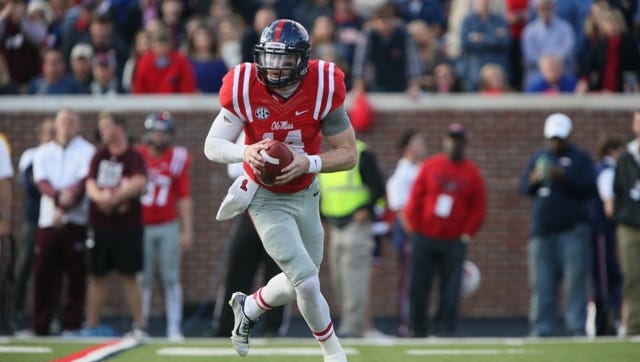 Ole Miss' Bo Wallace (14) rolls out to pass. Mississippi State played Ole Miss in a college football game on Saturday, Nov. 29, 2014 at Vaught-Hemingway  Stadium in Oxford, Miss. (Photo by Keith Warren)