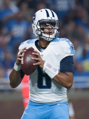 Tennessee Titans quarterback Marcus Mariota (8) drops back to pass during the first quarter against the Detroit Lions at Ford Field.