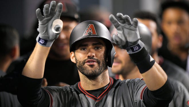 J.D. Martinez gestures toward the camera as he stands in the dugout after hitting his fourth home run of the game in the ninth inning. The Diamondbacks beat the Dodgers, 13-0.