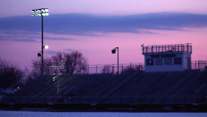 Backlit by the setting sun, the Kewanee Stadium lights flicker on during the April 17 #BeTheLight activity organized by football coach Brad Swanson. This Friday's will be the last one for the school year and be a part of the Illinois High School Association's three-day social media event to honor the Class of 2020.