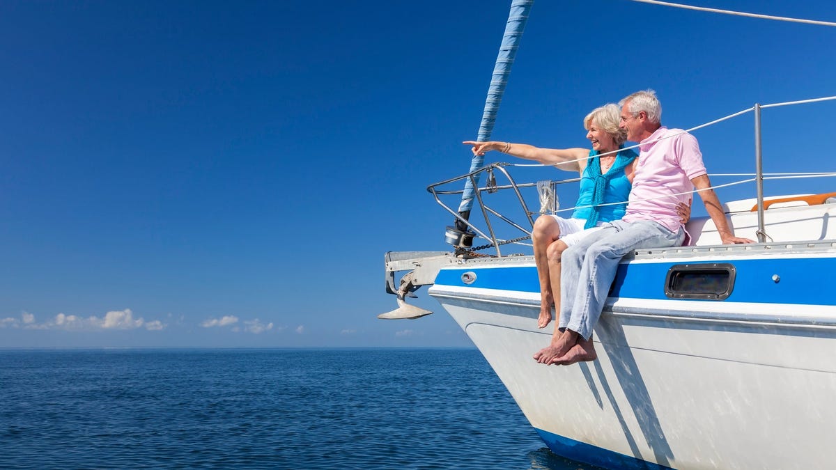 Senior couple sitting on boat looking out at the horizon