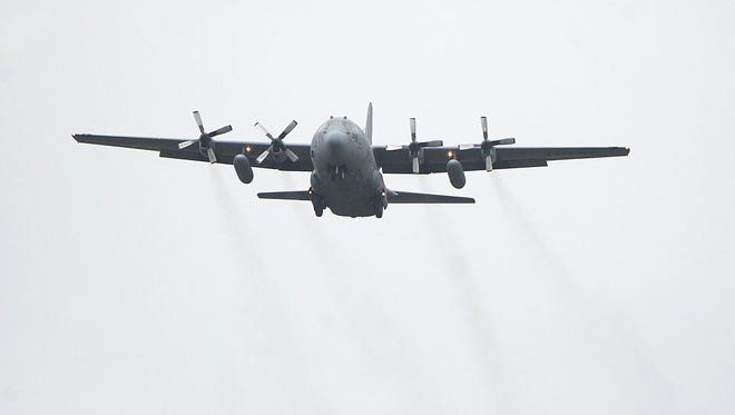 A C-130 carrying returning members of the 179th Airlift Wing of the Ohio Air National Guard passes over the base before landing in a News Journal file photo.