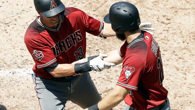 Arizona Diamondbacks' Nick Ahmed, left, is greeted by teammate Steven Souza Jr. after hitting a two-run home run during the fourth inning of a baseball game against the San Diego Padres, Sunday, July 29, 2018, in San Diego. (AP Photo/Gregory Bull)