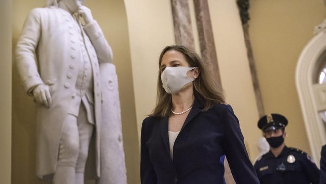 Judge Amy Coney Barrett, President Donald Trump's nominee for the Supreme Court, arrives for closed meetings with senators, at the Capitol in Washington, Wednesday, Oct. 21, 2020.