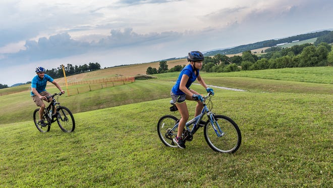Mike Keefer of Hanover and daughter Olivia Keefer, 12, train on mountain bikes at West Manheim Recreation Park on Monday. The father-daughter duo have started a youth mountain biking team called the Hanover Area Youth Composite Team.