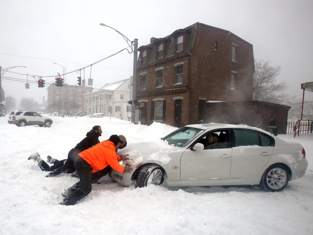 Joelle Price of Poughkeepsie, N.Y. gets help after her car got stuck in snow on Main St. in Beacon, N.Y. during Winter Storm Stella.