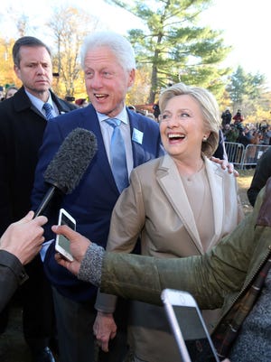 Former President Bill Clinton and Hillary Clinton greet the crowd at the Douglas Grafflin Elementary School in Chappaqua, after casting their vote Nov. 8, 2016. 