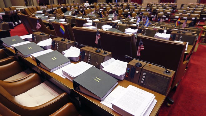 Budget bills sit on legislators' desks in the Assembly Chamber at the state Capitol on Monday.