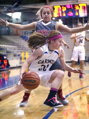 Carmel Lady Greyhound Abby Abel drives past Fishers Lady Tiger Brooke Sugg in the fourth quarter of the Lady Greyhounds' 55-43 home win on Tuesday, Jan. 20, 2015.