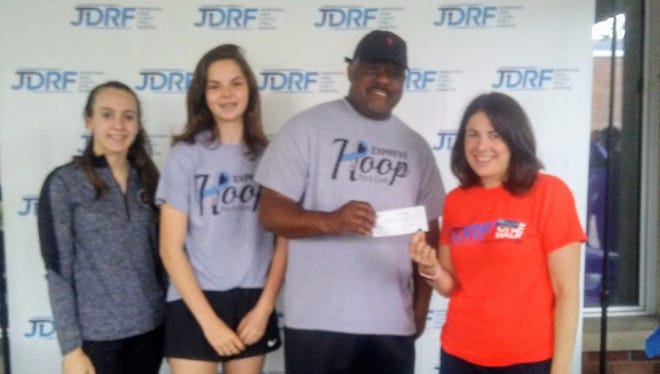Elmira JV girls coach A'Don Allen presents a check for $500 to JDRF Executive Director Sarah Goldstein Post on May 20, 2018 during the JDRF One Walk at Elmira College. Also pictured are Elmira players Emma Cleary, left, and Megan Fedor.