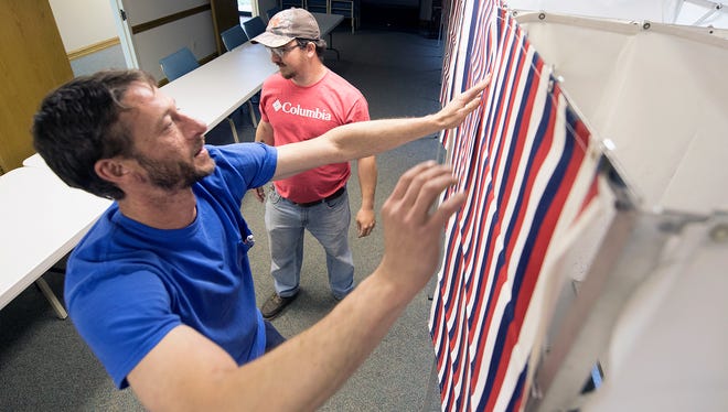 Forrest Cartwright, left, Zody's Moving and Storage, and Justin Wagaman, Franklin County employee, install voting booths Monday, May 14, 2018 at Cornerstone Church of Christ, Chambersburg. Polling places open at 7 a.m., Tuesday, May 15, for primary elections.