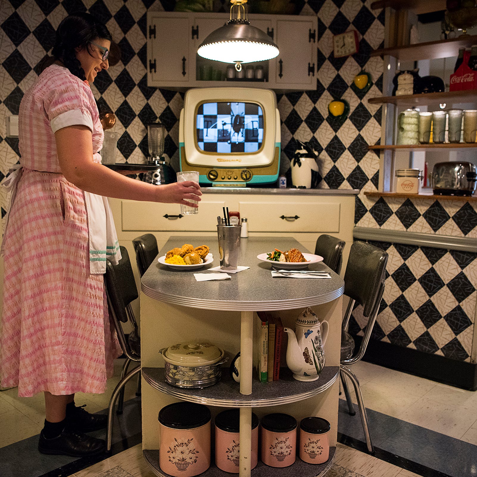 Jenn Havelock serves up an early lunch at 50's Prime Time Cafe at Disney World's Hollywood Studios theme park. The popular eatery makes diners feel right at home in the middle of the 20th century. Creature comforts at many of the tables include black