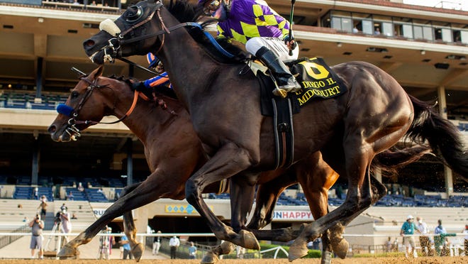 In this image provided by Benoit Photo, Maximum Security, outside, with Abel Cedillo aboard, overpowers Midcourt, inside, with Victor Espinoza aboard, to win the Grade II, $150,000 San Diego Handicap horse race Saturday, July 25, 2020, at Del Mar Thoroughbred Club in Del Mar, Calif. (Benoit Photo via AP)