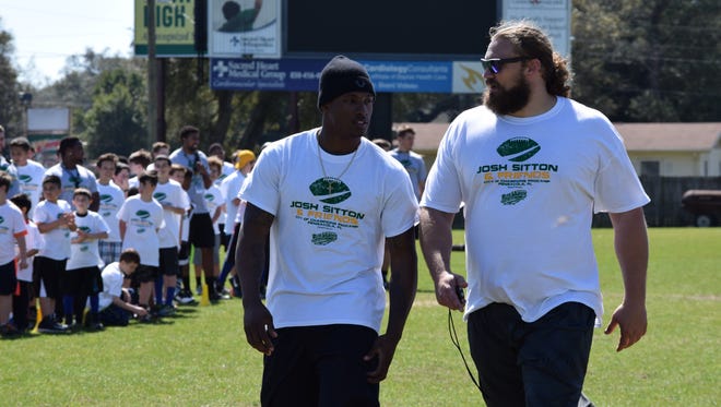 Green Bay Packers teammates and Pensacola residents Damarious Randall and Josh Sitton head to next drill at Saturday’s Josh Sitton ProCamp at Catholic High.