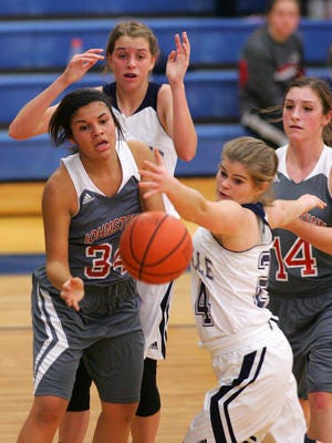 Maggie Wolf (front right), one of just two seniors on this season's Granville girls basketball team, scraps for a loose ball against Johnstown in 2014.