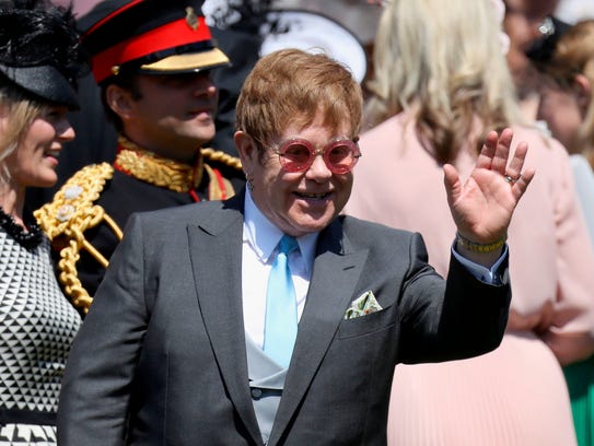 British singer-songwriter Sir Elton John waves as he