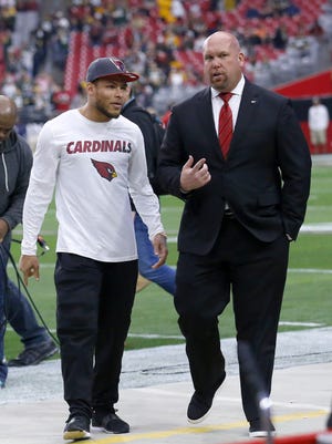 Injured Arizona Cardinals free safety Tyrann Mathieu talks with General Manager Steve Keim  prior to their NFL game against the Green Bay Packers Sunday, Dec. 27, 2015 in Glendale, AZ.
