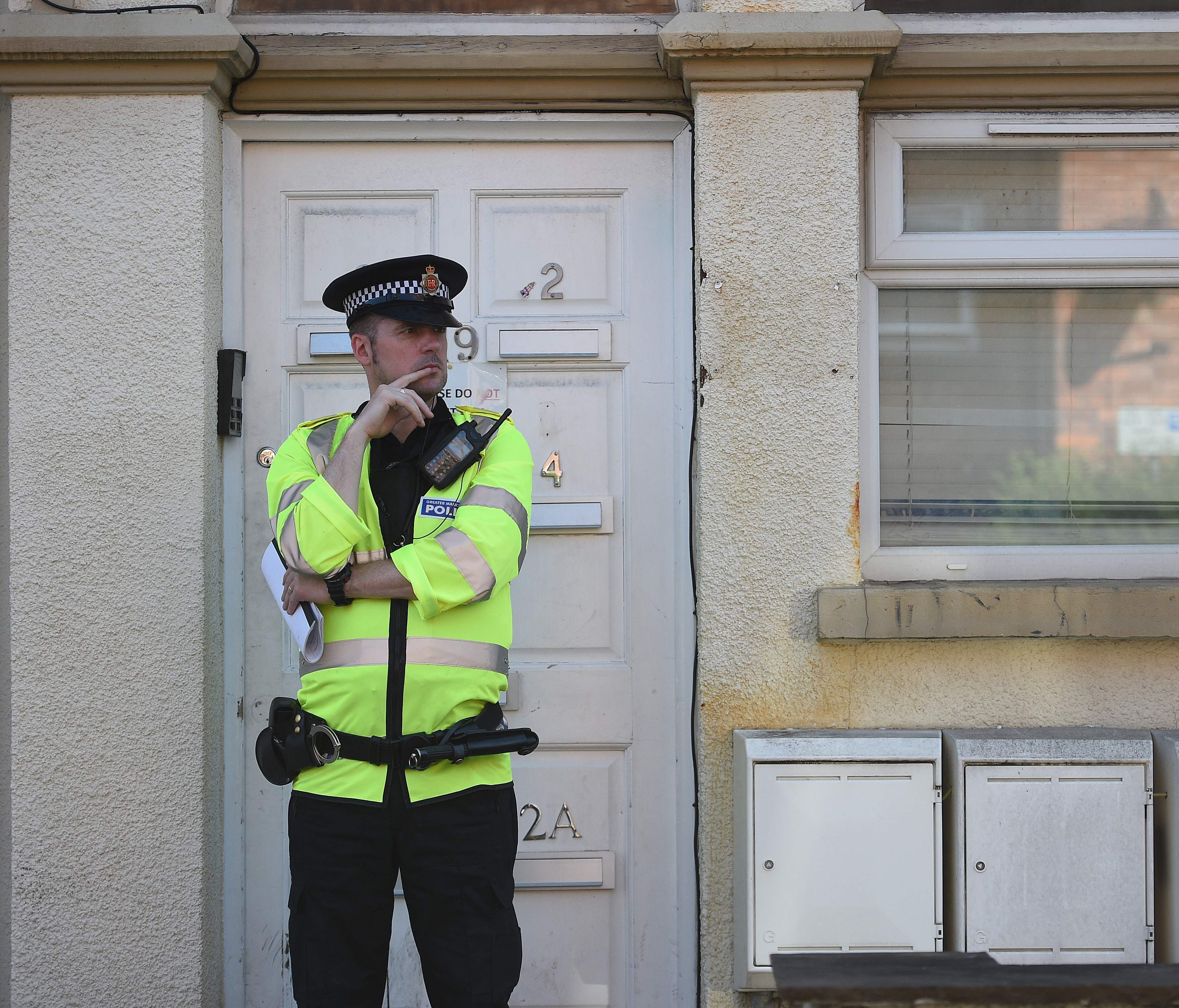 A police officer stands on duty outside a residential property on Egerton Crescent in Withington, Manchester, on May 25, 2017, as their investigations continue into the May 22 terror attack at the Manchester Arena.