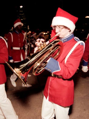 West High School band member Michael Cox warms up before the start of the WIVK Santa Parade on Friday, December 11, 1998.