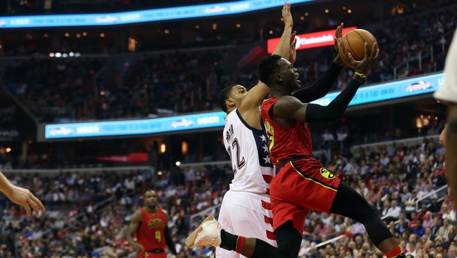 Atlanta Hawks guard Dennis Schroder (17) shoots the ball as Washington Wizards forward Otto Porter Jr. (22) defends in the second quarter in Game 5 of the first round of the 2017 NBA Playoffs at Verizon Center.
