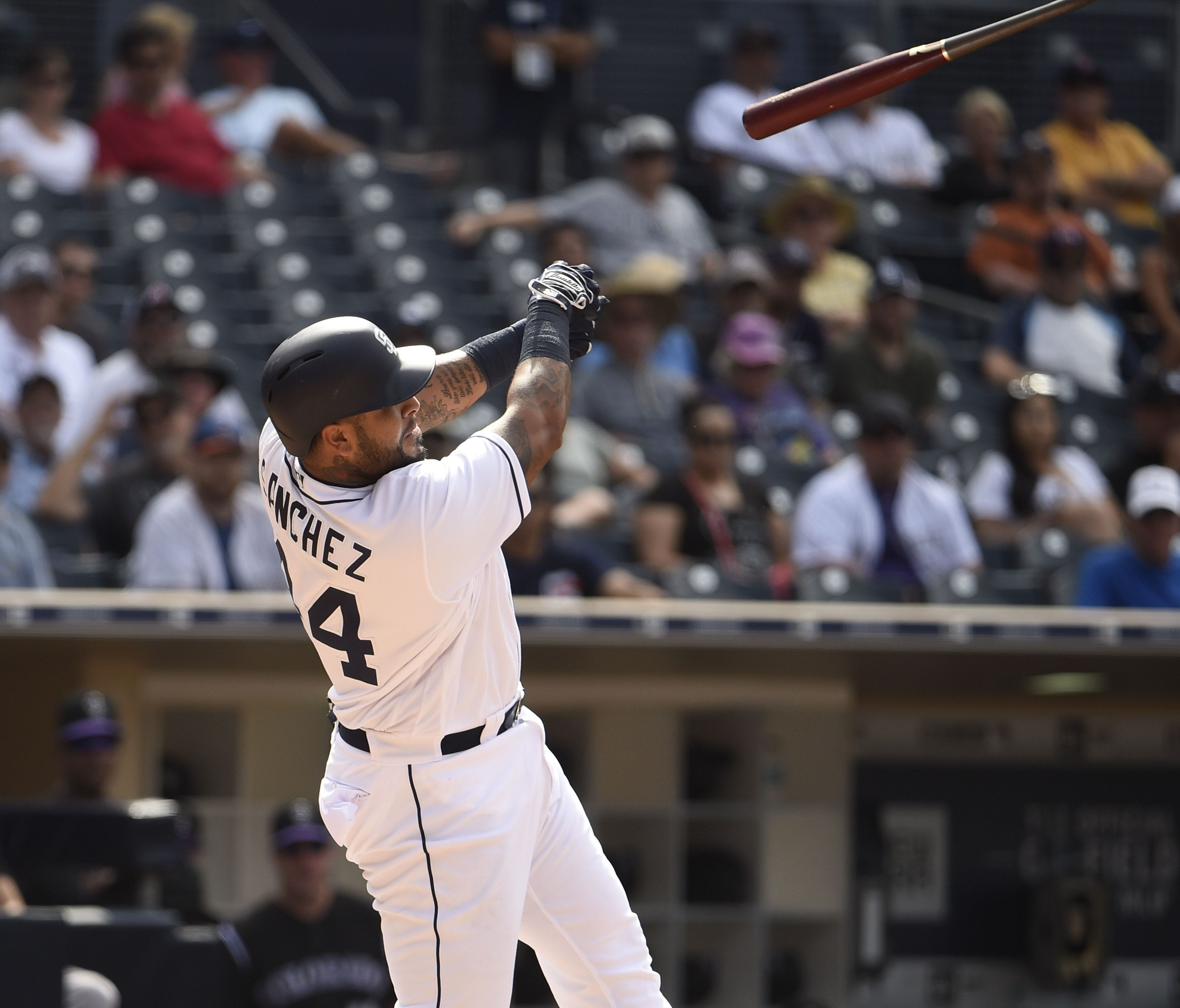 Padres' Hector Sanchez loses his bat that lands in the stands.