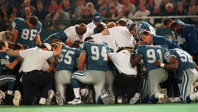 Detroit Lions players and staff pray on the field after Reggie Brown was taken off the field in an ambulance in the fourth quarter of their game with the New York Jets Sunday, Dec. 21, 1997, in Pontiac, Mich.