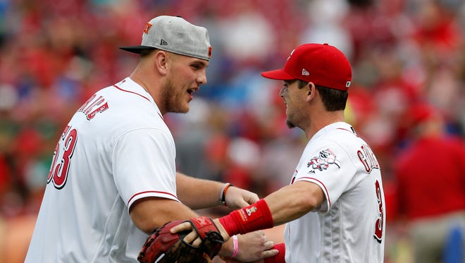 Cincinnati Bengals first round draft pick Billy Price shakes hands with Cincinnati Reds second baseman Scooter Gennett (3) after throwing a ceremonial first pitch before the first inning of the MLB National League game between the Cincinnati Reds and the Chicago Cubs at Great American Ball Park in downtown Cincinnati on Friday, June 22, 2018.