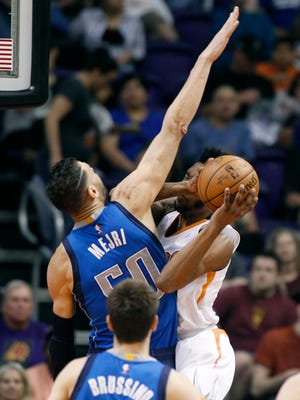Dallas Mavericks center Salah Mejri (50) defends the shot of Phoenix Suns forward Derrick Jones Jr., right, during the first half of an NBA basketball game on Sunday.