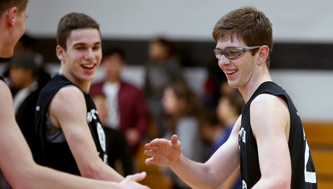 Tyler Yost, right, from Olympic is congratulated after making the winning basket at the West Sound Senior All-Star basketball game Tuesday night at Olympic College's Bremer Student Center.