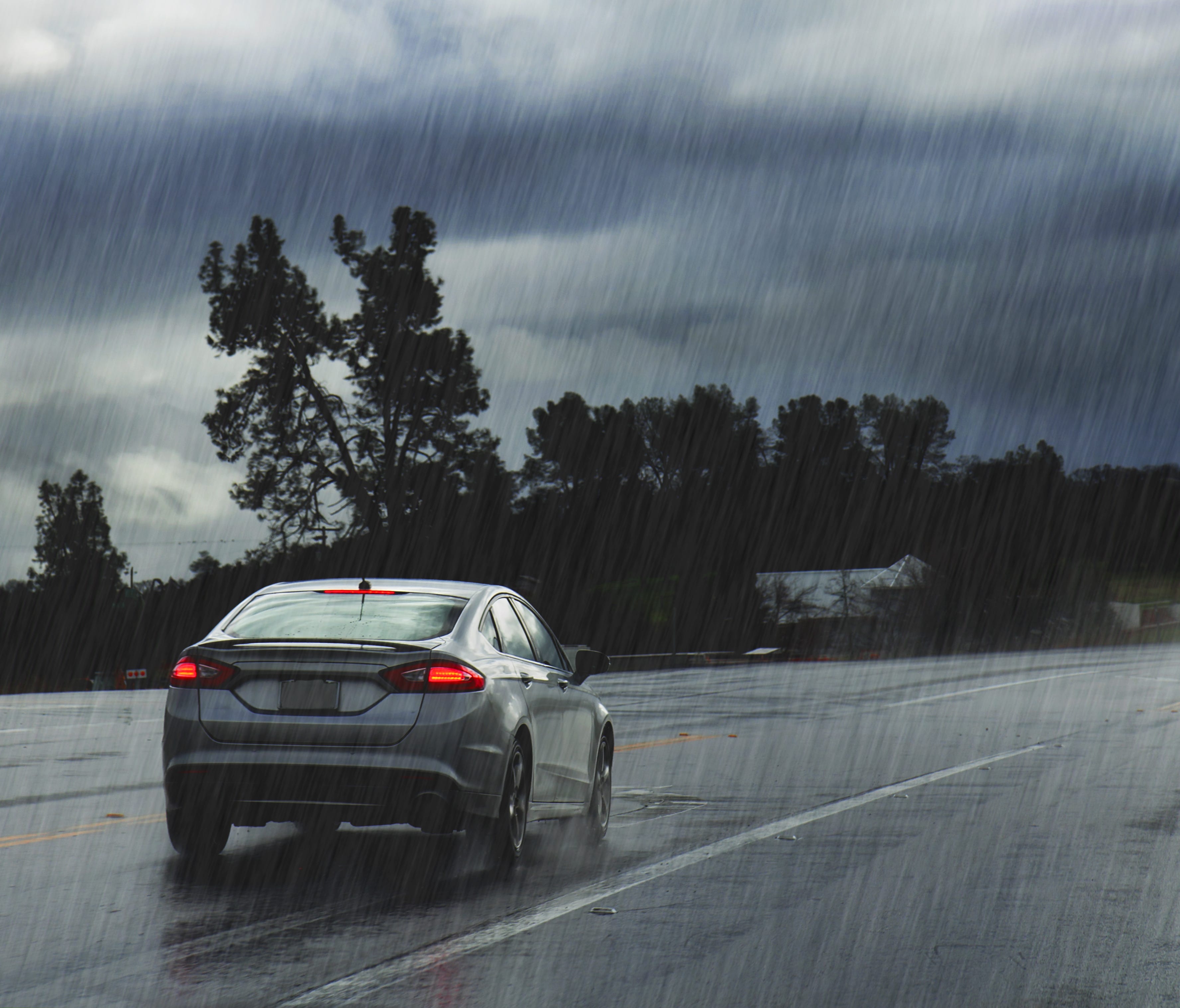 Rainy road with car
