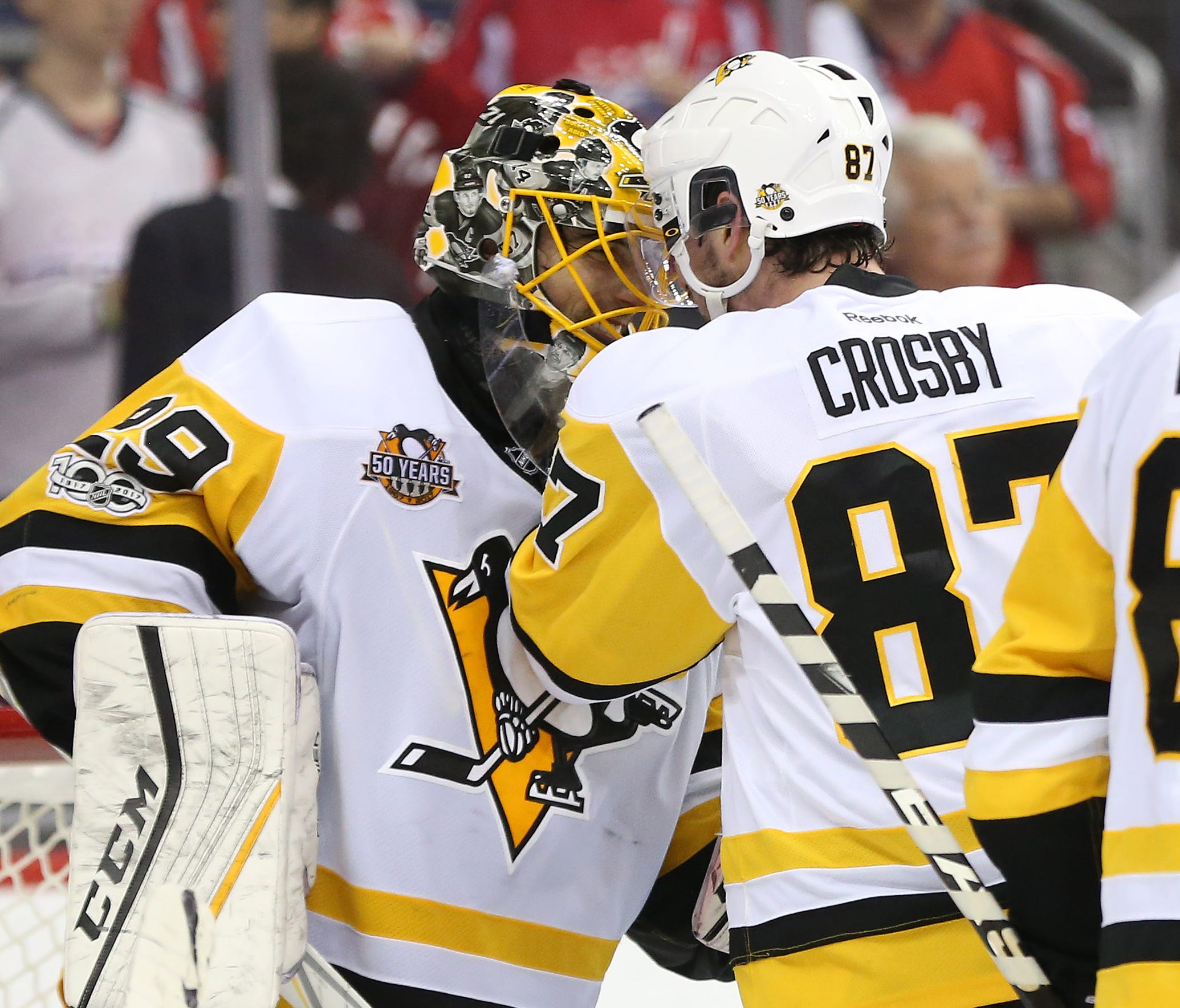 Pittsburgh Penguins goalie Marc-Andre Fleury (29) and center Sidney Crosby (87) celebrate after defeating the Washington Capitals 2-0 in Game 7.