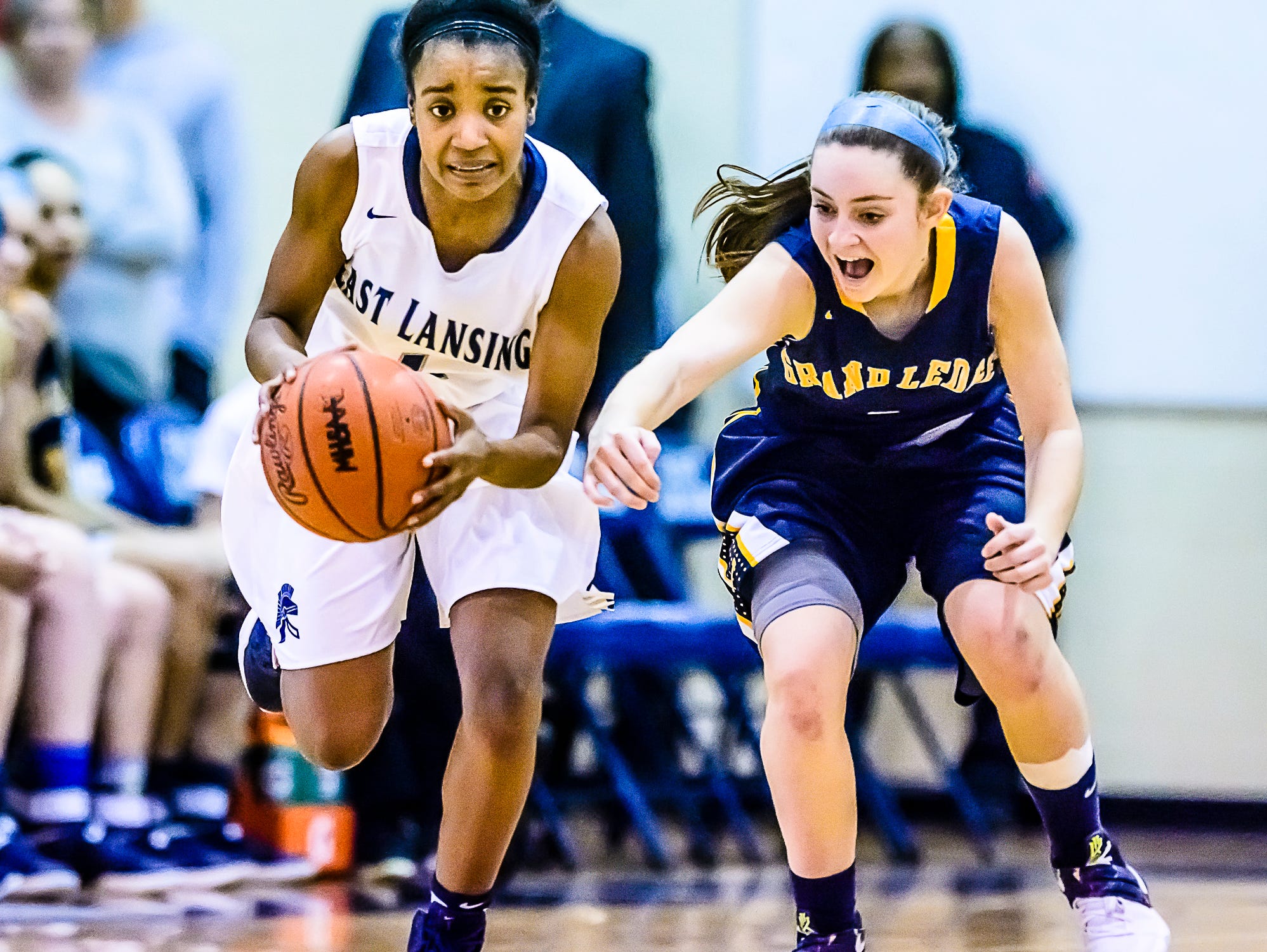 Sanaya Gregory ,left, of East Lansing steals the ball from Mackenzie Todd of Grand Ledge during their district semifinal game Wednesday March 1, 2017 at East Lansing High School. KEVIN W. FOWLER PHOTO