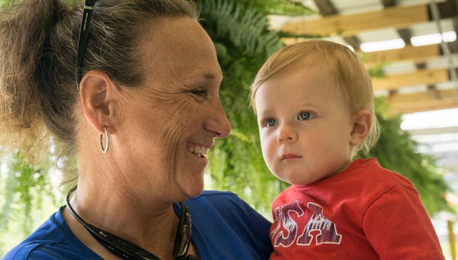 Mary Hauk holds the next generation of farmers, 1-year-old grandson Maddox Lancucki, in this 2018 file photo.