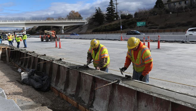 Granite Construction workers build a concrete barrier rail at the westbound Virginia Street exit on Dec. 15, 2011.