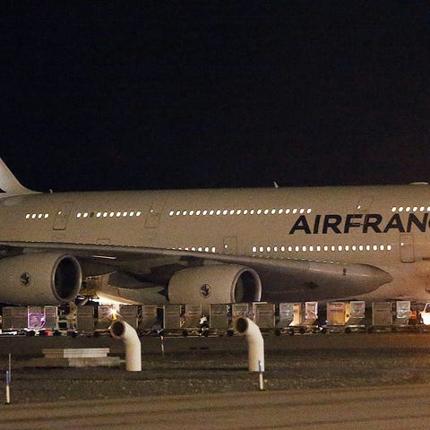 Emergency vehicles are parked near an Air France p
