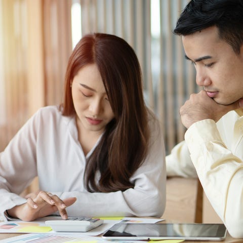 Two adults looking at financial paperwork.