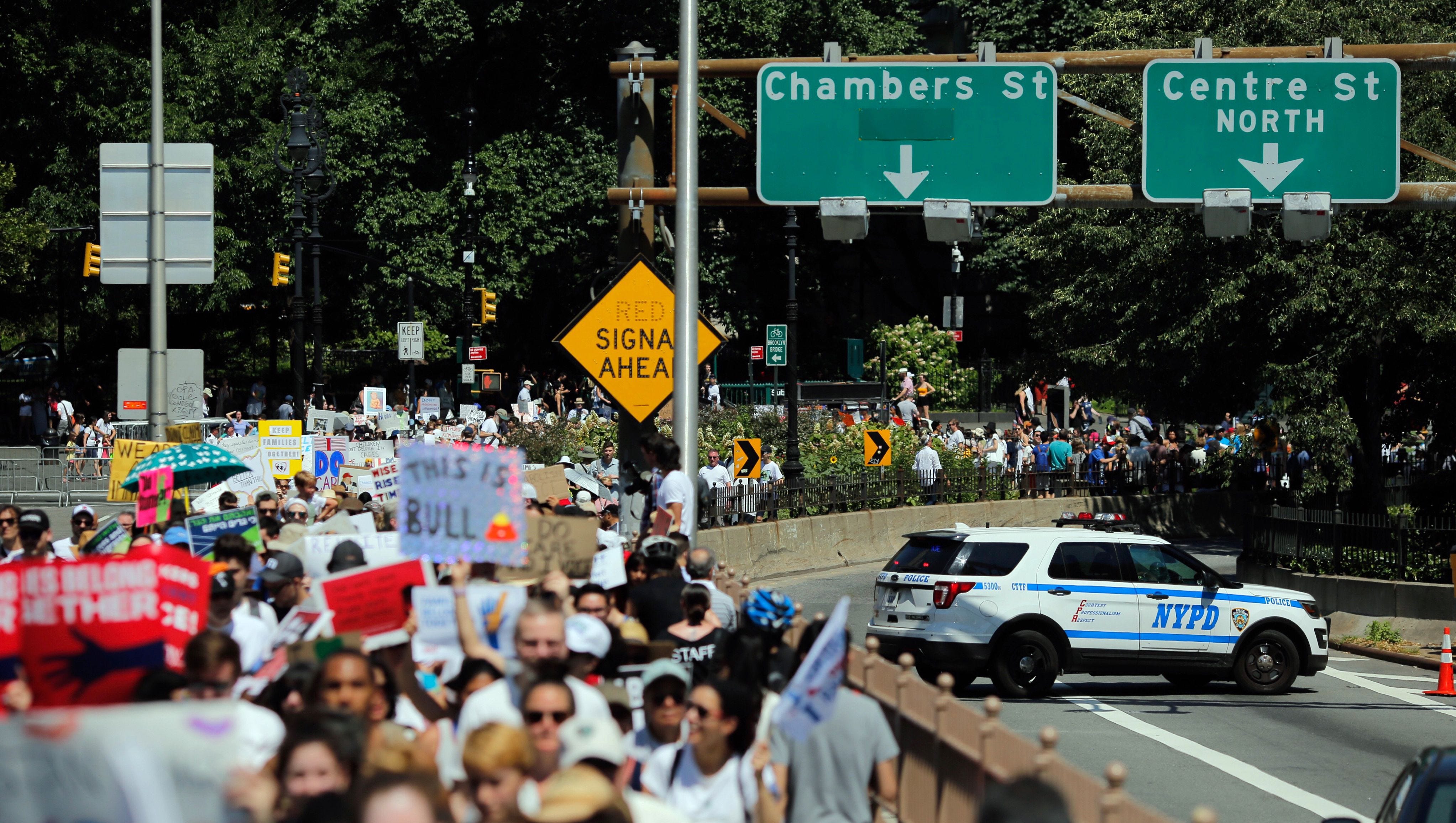 People march during the Families Belong Together