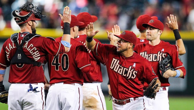 Arizona Diamondbacks left fielder David Peralta (6) high-fives teammates after the 7-2 victory over the San Diego Padres at Chase Field in Phoenix, AZ, on Sunday, June 21, 2015.